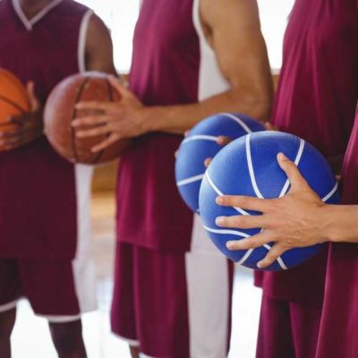basketball-players-holding-basketball-in-court