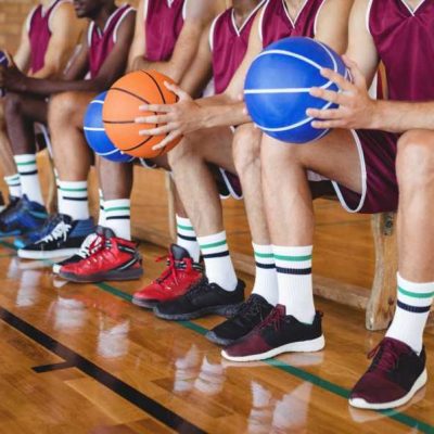 basketball-players-sitting-on-bench-with-basketball